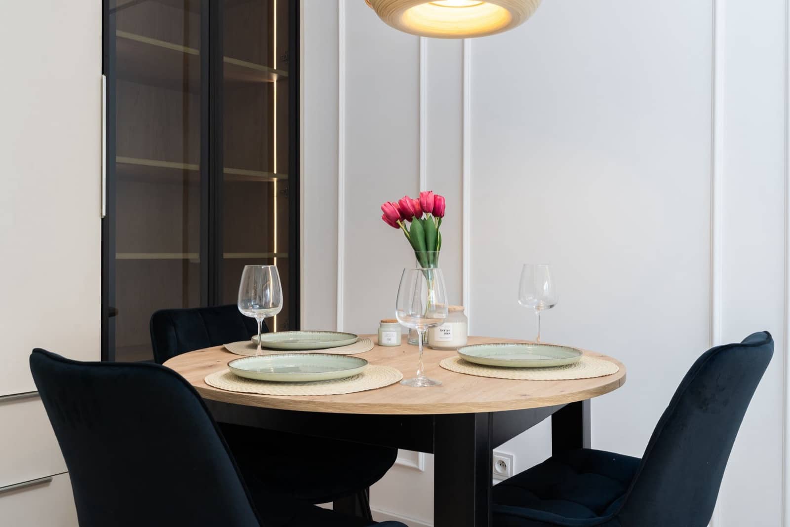 A dining table set with plates and glasses for arriving guests