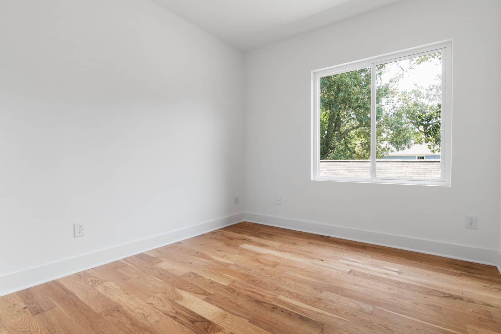 An empty, freshly cleaned room with bright windows after a move-out clean